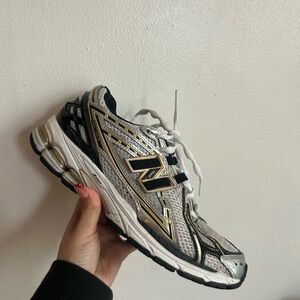 New Balance Women's White and Black Sneakers with Gold Accents